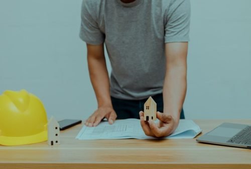 engineer-holding-little-wooden-house_38816-990